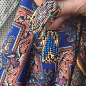 Seed beaded pierced hoop earrings on a gold tone base by Treasure Jewelry.